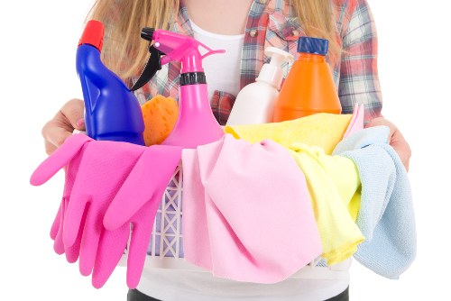 Professional home cleaners in Queenspark tidying a modern living room