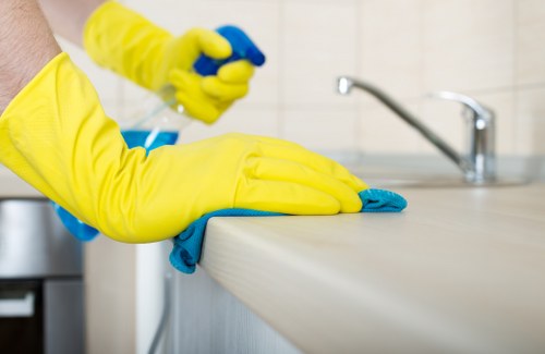 Queenspark office cleaning team sanitizing desks and shared workspaces